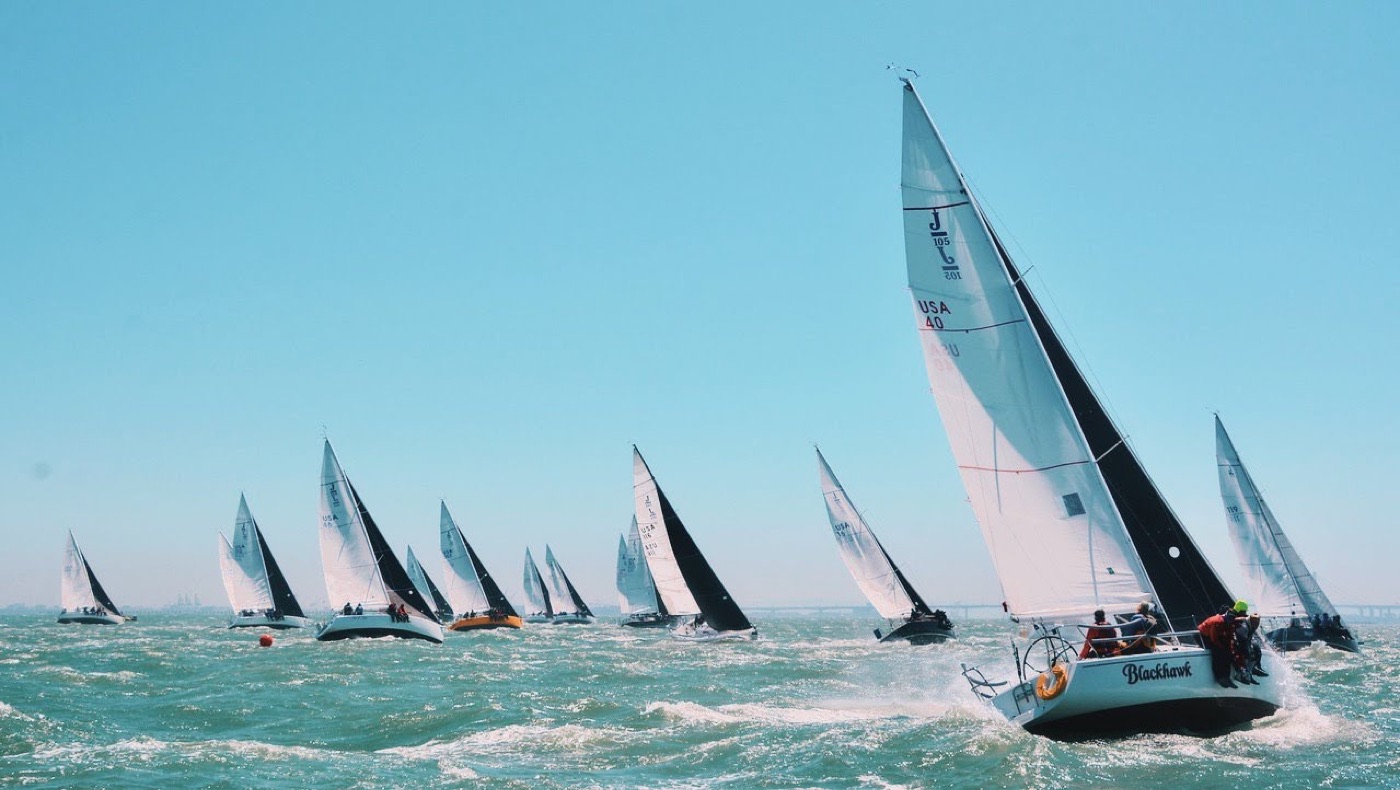 A fleet of sailboats racing across open water